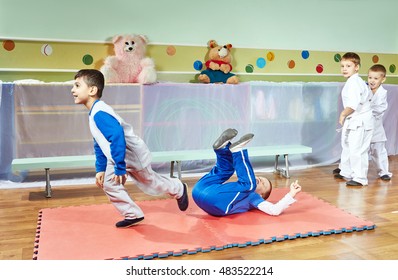 Children Athletes Train Tumbling On The Mats