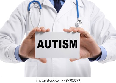 Children Autism Concept. Male Doctor Holding Paper On White Background, Closeup