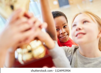 Children At An Award Ceremony With The Trophy After A Sports Competition