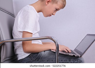 Children Bad Poor Sitting Posture. Boy Using Laptop Computer