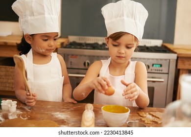 Children bake in kitchen for learning and development of baker skill, fun with baking ingredients and chef hat with apron. Childhood, focus and girl kids making cookies, diversity and work together.