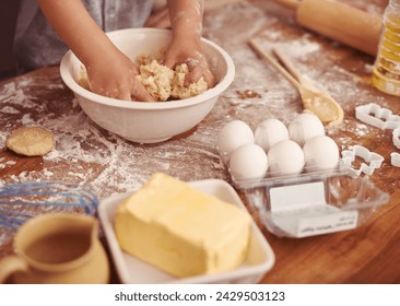 Children, baking and hands in kitchen with dough, home and learning with ingredients for dessert cake. Kids, kneading and playing with flour on table, love and eggs for butter biscuits on holiday - Powered by Shutterstock