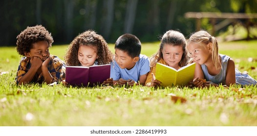 Children, books and lying in park with friends, learning or diversity for reading at school playground. Kids, education or study with support, mockup space or solidarity at multicultural kindergarten - Shutterstock ID 2286419993