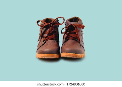 Children boots isolated on tuquoise background with clipping path, Stylish baby shoes

