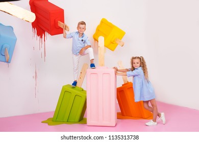 Children, the boy and girl are happy with the sale and are holding a huge ice cream - Shutterstock ID 1135313738
