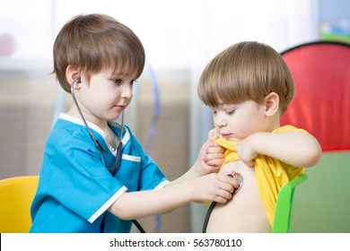 Children boy playing doctor in playroom or kindergarten
