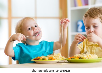 Children Boys Eating Healthy Food In Kindergarten Or At Home