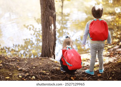 Children with briefcases for a walk in park. School break. The beginning of the children's studies. - Powered by Shutterstock