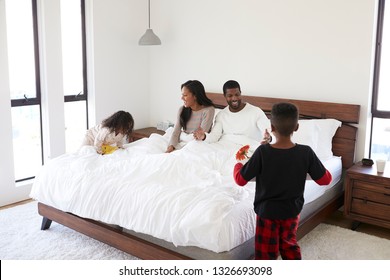 Children Bringing African American Parents Breakfast In Bed To Celebrate Mothers Day Fathers Day Or Birthday