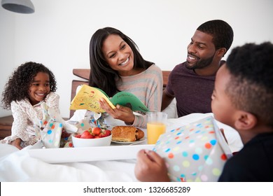 Children Bringing Mother Breakfast In Bed To Celebrate Mothers Day Or Birthday - Powered by Shutterstock