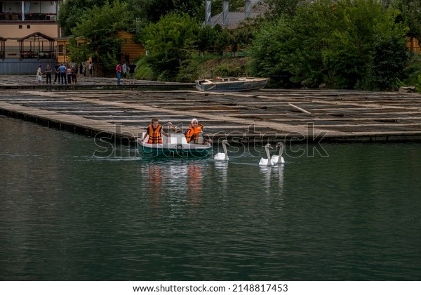 children chasing birds with boat in the lake.\
Dagestan Russia\
24.10.2021