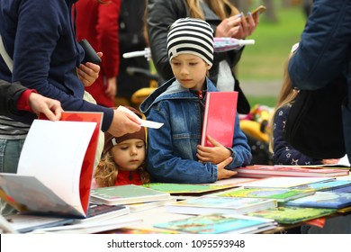 Children Choosing And Buying Books At The Book Fair