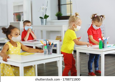 Children In The Classroom In Medical Masks For Respiratory Protection, Mixed Race