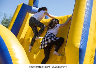 Children Climb An Inflatable Slide. Inflatable Obstacle Course For Fun. Active Rest For Children. Inflatable Playground. Sports And Fun.