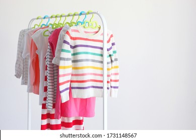 Children clothes on a rack on a light background. Children's clothing, children's stores.
 - Powered by Shutterstock