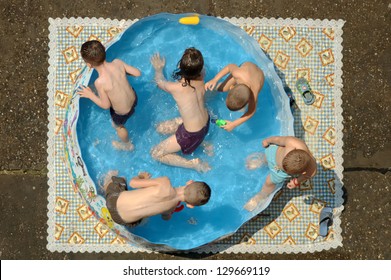 Children In A Colorful Kiddie Pool.