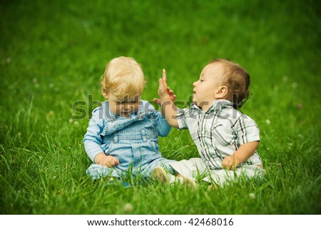 Similar – Two children laughing while playing in the playground.