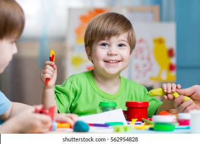 Children Creativity. Kids Sculpting From Clay. Cute Little Boys Mould From Plasticine On Table In Kindergarten