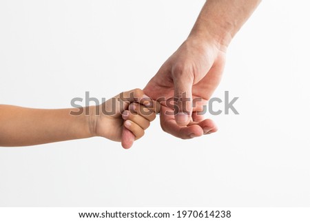 Children Custody Concept. Cropped close up of little girl holding father's finger, enjoying spending free time together, isolated over white studio background. My Dad Is A Hero And Best Friend