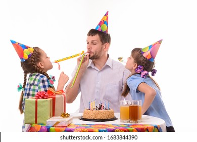 Children And Dad Joyfully Blow Whistles To The Horns At A Birthday Party