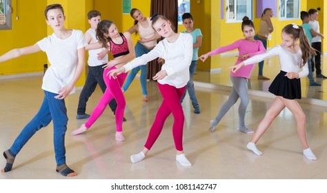 Children Dancing Synchronous Group Choreography With Female Coach In Dance Hall