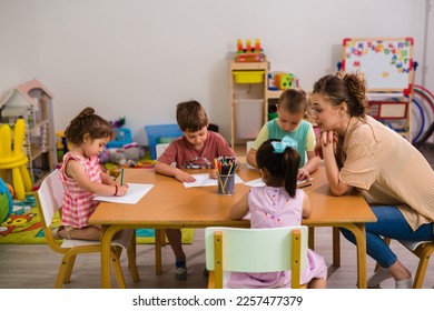 Children in the daycare are drawing on the table - Shutterstock ID 2257477379