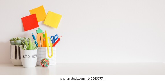 Children Desk With School Supplies Near White Wall Mockup.