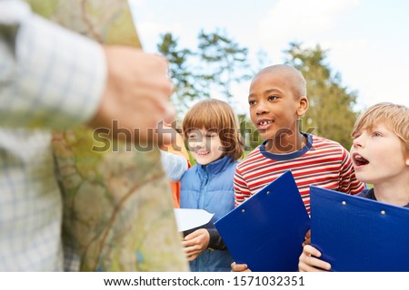 Children as detectives and explorers on a treasure hunt or scavenger hunt with clipboard