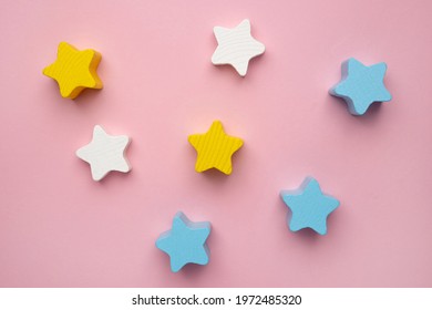 Children developmental toy for the development of motor skills, a crescent wooden stars balancer, on a pink background top view - Powered by Shutterstock