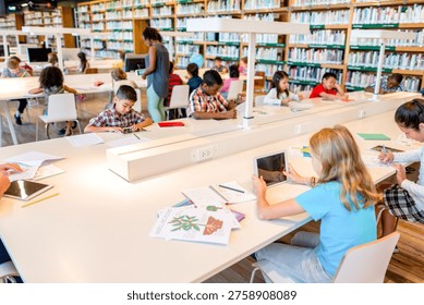 Children of diverse backgrounds studying and using tablets in a bright library. Shelves filled with books create a focused and educational atmosphere. - Powered by Shutterstock - Get 15% off with code: PIKWIZARD15