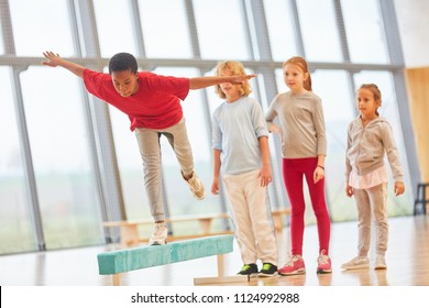 Children Do School Sports And Balance On A Balance Beam