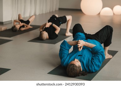 Children do yoga in the gym under the guidance of an instructor. Children's gymnastics - Powered by Shutterstock