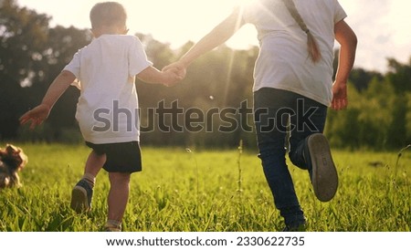 Similar – Image, Stock Photo Two teenagers race through the sunshine on a sled, dusted with snow