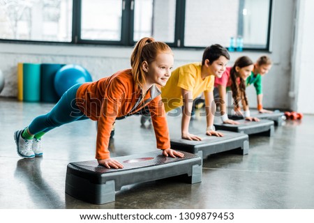 Children doing plank exercise with step platforms 