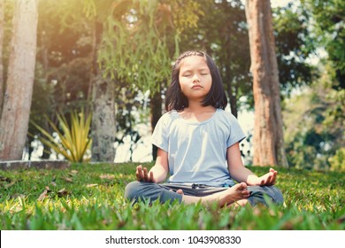 Children Doing Yoga On Grass With Sunshine In The Park