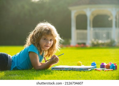 Children Draw Paint Pictures Outside, Childrens Creativity. Child Boy Enjoying Art And Craft Drawing In Backyard Or Spring Park. Children Drawing Draw With Pencils Outdoor.