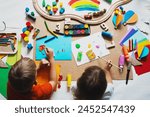 Children drawing and making crafts in kindergarten or daycare. Little kids with educational toys and supplies for creative. Сhildren education and development in preschool or childcare.