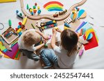 Children drawing and making crafts in kindergarten or daycare. Little kids with educational toys and supplies for creative. Сhildren education and development in preschool or childcare.