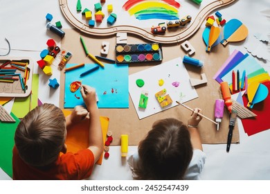 Children drawing and making crafts in kindergarten or daycare. Little kids with educational toys and supplies for creative. Сhildren education and development in preschool or childcare. - Powered by Shutterstock