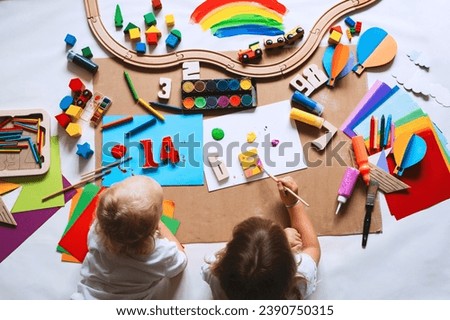 Children drawing and making crafts in kindergarten or daycare. Little kids with educational toys and supplies for creative. Сhildren education and development in preschool or childcare.