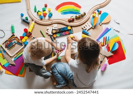 Children drawing and making crafts in kindergarten or daycare. Little kids with educational toys and supplies for creative. Сhildren education and development in preschool or childcare.