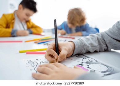 Children drawing paint with colorful pencils coloring book in educational class at school. Art creative lessons developing imagination fine motor skills - Powered by Shutterstock