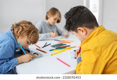 Children drawing paint with colorful pencils coloring book in educational class at school. Art creative lessons developing imagination fine motor skills - Powered by Shutterstock