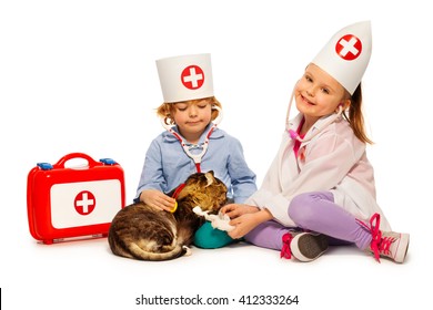 Children dressed at whites bandage paw to a cat