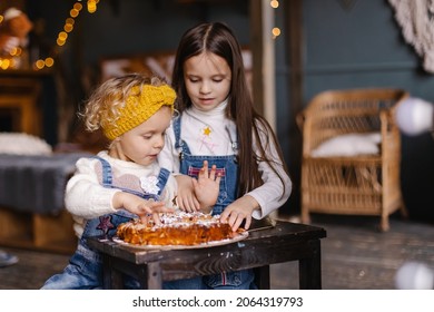 Children eat delicious cake with their hands. Homemade baking. Thanksgiving holiday life moments. Lifestyle siblings sisters