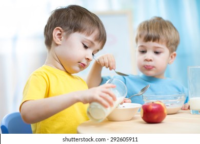 children eating healthy food in kindergarten or nursery
