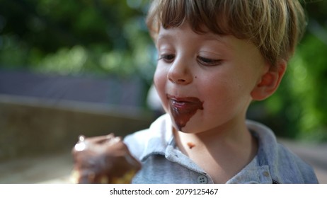 Children Eating Ice-cream Outside. Two Kids Eating Chocolate Icecream Cones