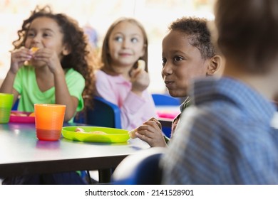 Children eating snacks in elementary school classroom