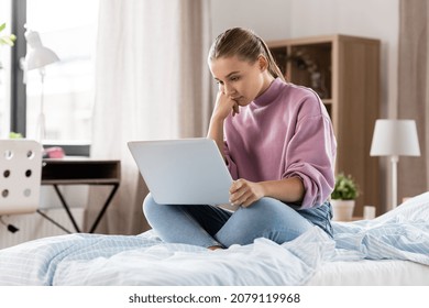 Children, Education And Learning Concept - Sad Student Girl With Laptop Computer At Home