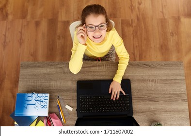 children, education and school concept - happy smiling student girl typing on laptop at home - Powered by Shutterstock